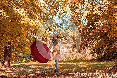 Fun in the autumn forest â€“ woman with umbrella enjoying in nat Stock Photo